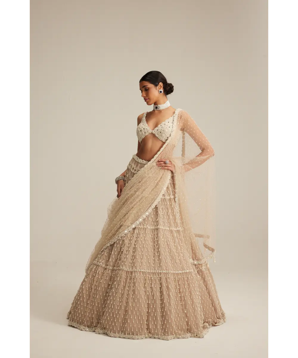 VVANI VATS- Light Beige Pearl Drop Multi Tier Lehenga Set.